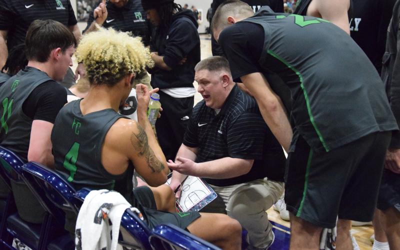 Coach Jason Shaver gives his team instructions during a timeout in the Region 8AA championship game Friday at Prince Avenue Christian School in Bogart.