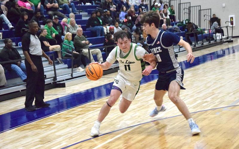 Bentley Huff drives past a Prince Avenue defender in Franklin County's Region 8AA semifinal win Wednesday night in Bogart.