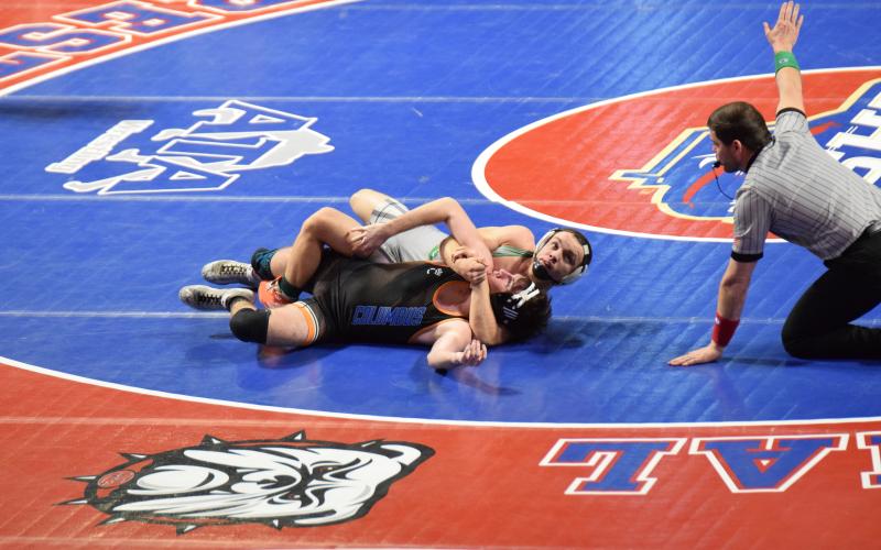 Franklin County Lion Josh Baughcum wraps up an opponent during his run to the Class AA 150-pound state championship. (Photo by Shane Scoggins)