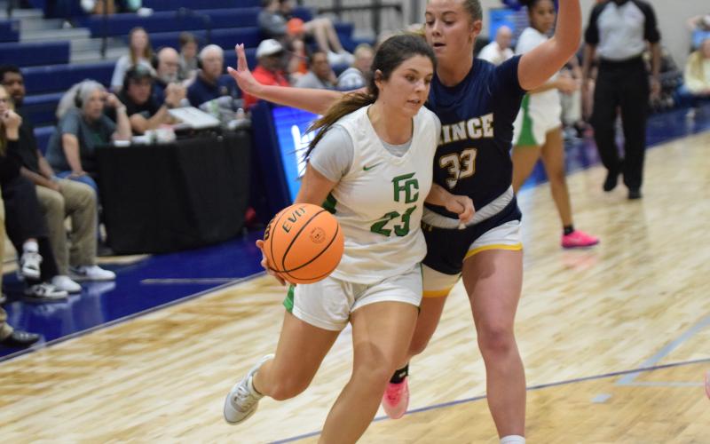 Bella Rosene drives to the basket against Prince Avenue in the Region 8AA consolation game Friday in Bogart. Rosene made the game-winning basket Tuesday to send the Lady Lions to the second round of the state playoffs. (Photo by Shane Scoggins)