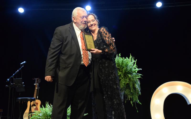 Sid Ginn hugs Franklin County Chamber of Commerce Director Rachel Howington after receiving the Charles E. Bradshaw Citizen of the Year Award.