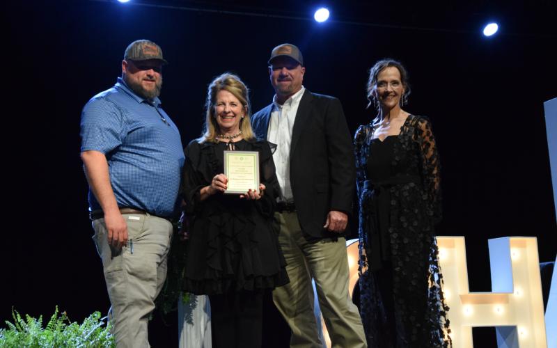 Jeremy Fulghum and Richie Fulbright of Ed Murdock Superstores received the Bruce Knighton Business of the Year Award from Susan Knighton and Howington.