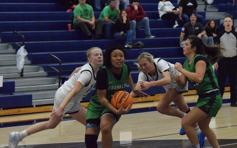 Senior Ta’Kiah Winkfield gets by two Coahulla Creek defenders on her way to the basket in a Sweet 16 game in Dalton Friday. (Photo by Shane Scoggins)