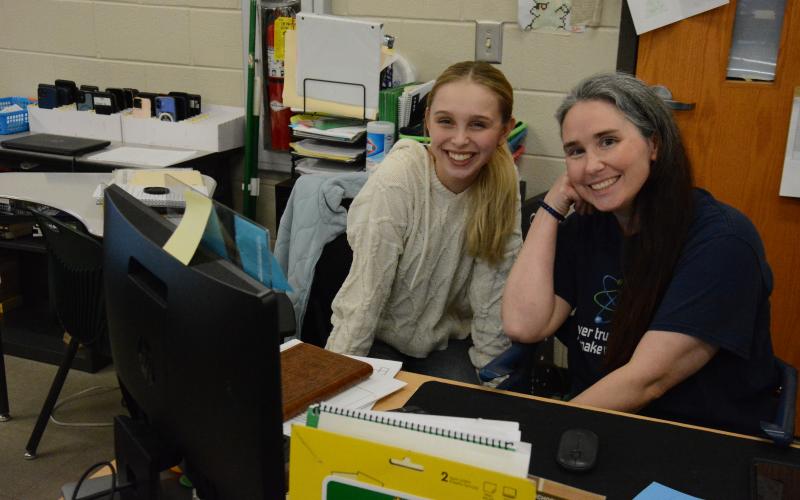 FCHS teacher Brandie Thomas consults with student Charlize Smith during her physical science class. Thomes is one of about one million Americans diagnosed with multiple sclerosis (MS). She is sponsoring a fundraising Walk for MS on March 14 at Ed Bryant Stadium. The money raised will go to the National MS Society, which funds research to find a cure. (Photo by Charlie Eavenson)