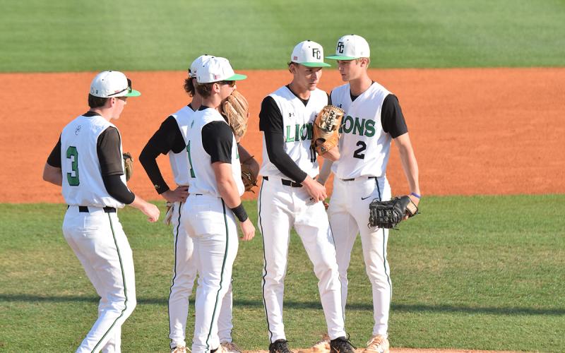 Members of the Franklin County Lion infield gather around pitcher Caden Cawthon during Wednesday's Region 8AA game against Stephens County in Carnesville. (Photo by Shane Scoggins)