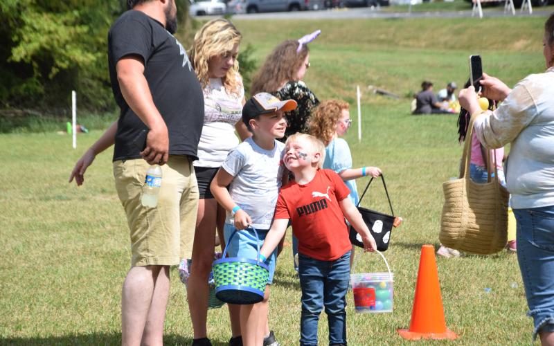 One of the hundreds of Easter egg hunters attending the Lavonia hunt Saturday sneaks an egg from a brother’s basket during a photo opportunity.