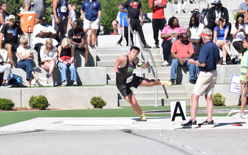 Candler Stone winds up to make a throw during the State Championship Meet Thursday in Athens. Stone won his second-consecutive state shot put championship with the second longest throw in the meet, regardless of classification.