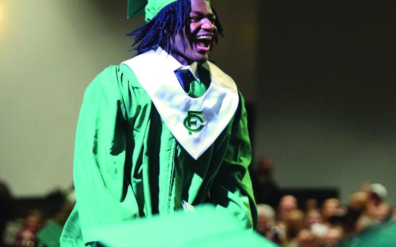 The Franklin County High School Class of 2026 – including Rico Adams (left) – happily received their diplomas Friday even after the commencement ceremony was forced into The Swails Center at Emmanuel University by bad weather. For more photos from the annual FCHS graduation, see Pages 6A-7A. (Photos by Shane Scoggins)