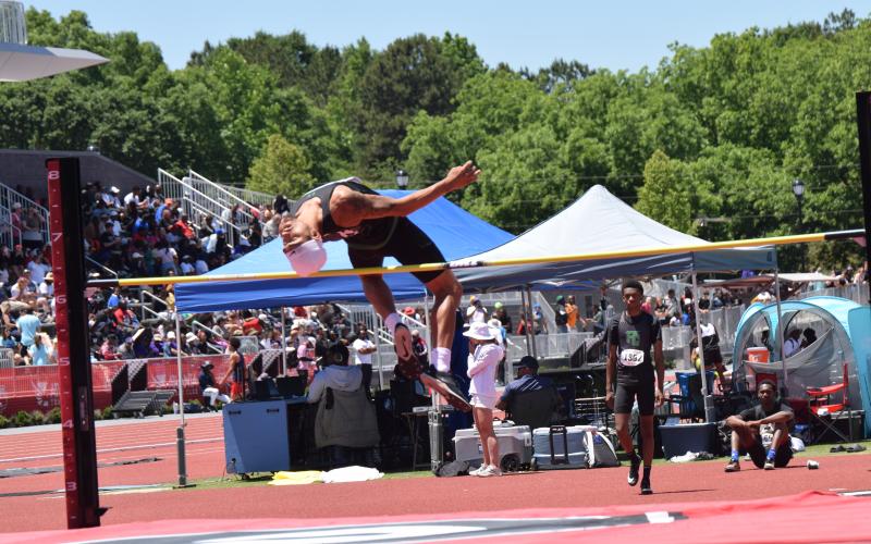Nava Ware clears the bar in the high jump at the state meet. (Photo by Shane Scoggins)
