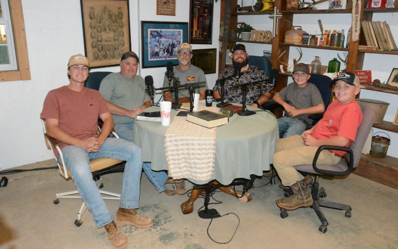 Colt Hart of Sandy Cross says his goal with the Dirt Road Disciples podcast is to share the Gospel of Jesus Christ. The podcast group includes (from left)  Parker Hobson, Billy Dial, Jeremy Sharpton, Hart and Hart’s sons Sage and Briar. Not pictured are Jacob Pittman and Tim Smith. (Photo by Charlie Eavenson)