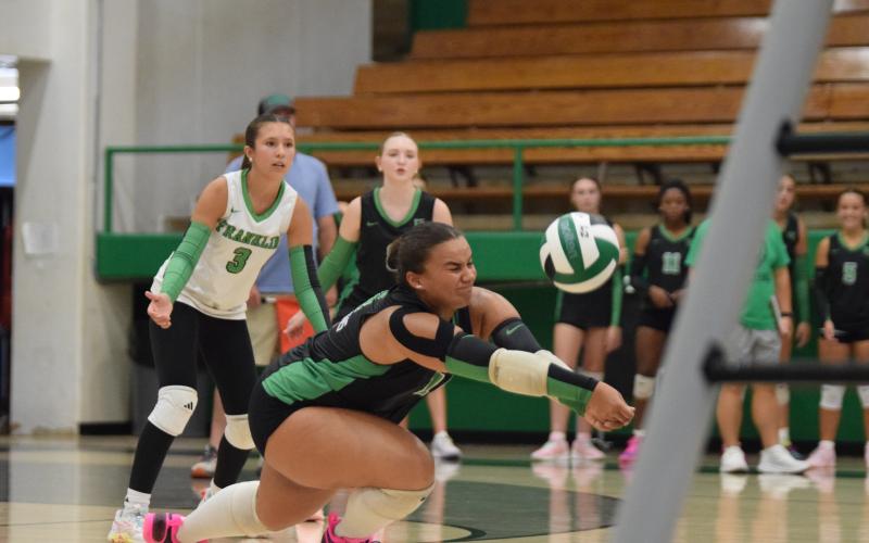 Senior Kallie Thrift digs a ball Tuesday in action against Rabun County in the Lion’s Den. Thrift and the Lady Lions swept Rabun and East Jackson in the three-team match. (Photo by Shane Scoggins)