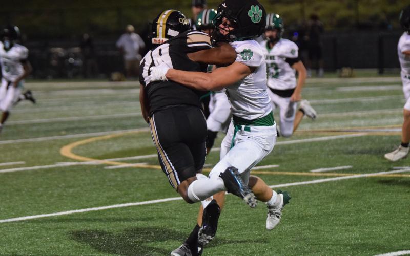 Elliott Harbin latches on to an East Hall ballcarrier for one of the Lion’s 23 tackles in Friday’s game, which set a new single game school record for tackles.