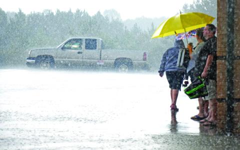 Franklin County Lion football fans first waited out a rainstorm (left) Friday but then had to line up at ticket boots for refunds after the game between Franklin County and Habersham Central was cancelled due to lightning. The game has been rescheduled for Sept. 27.