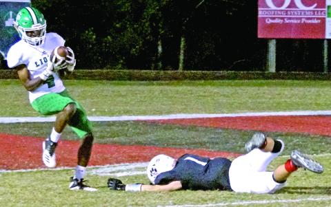 Lion Josh Beasley hauls in a tipped pass for a touchdown Friday night against Jackson County. (Photo by Manus)