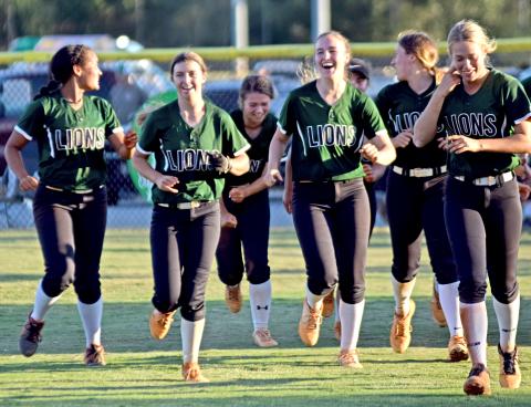 The Franklin County Lady Lions celebrate on the field Thursday after eliminating Coahulla Creek with a 14-0 win at FCHS.