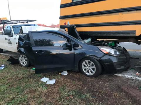 The driver of a Kia Rio was injured Thursday when his car was rear-ended and pushed into and under a school bus that was stopped to pick up a student. (Photo courtesy of Jordan Britton)