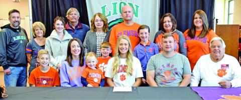 Pictured at Jaden Cheek’s scholarship signing with Clemson University last week are (front, from left) Carson Cheek, Megan Cheek, Cullen Cheek, Jaden Cheek, Jeff Cheek, Joe Cheek, (back) Joey Cheek, Sherri Cheek, Alex McLeroy, Mike Carson, Ellene Carson, Tucker Ruark, Matt Ruark, McKinlee Turner, Terri Cheek and April Ruark. Jaden is also the granddaughter of the late Raynell Cheek.