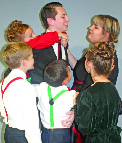 The Baileys – George (Noah Umbehant), Mary (Victoria Burns), Pete (Hunter Collins), Tommy (Brock Fowler), Janie (Mia Patterson) and Zuzu (Colbie Patterson) – embrace as a family in a scene from the beloved Christmas classic “It’s A Wonderful Life.” Franklin Community Players will bring the a play version of the beloved movie to the Lavonia Cultural Center  this weekend. Showtimes are Friday at 7 p.m., Saturday at 2:30 and 7 p.m. and Sunday at 2:30 p.m.  Tickets are $12.50, and seats are reserved.   Tickets 