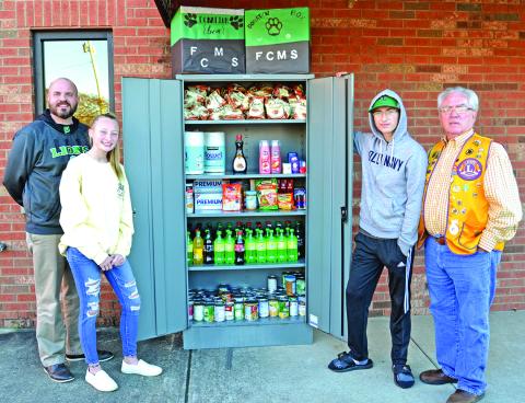 Attending the unveiling of the Franklin County Middle School Leo Club’s Take and Give Box at the Lavonia Police Department are (from left) FCMS Principal C.J. Wilder, Leo Club members Lealyn Day and Tyler Albrecht and Lavonia Lions Club member David Howell. (Photo by Eberhardt)