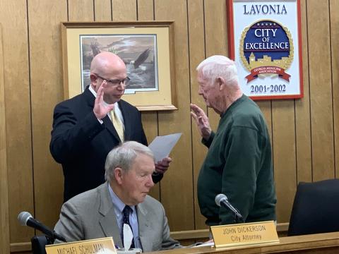 Lavonia Mayor Ralph Owens (right) swears in new Councilmember Michael Schulman (left) during Owens’ final meeting as mayor. City Attorney John Dickerson looks on.