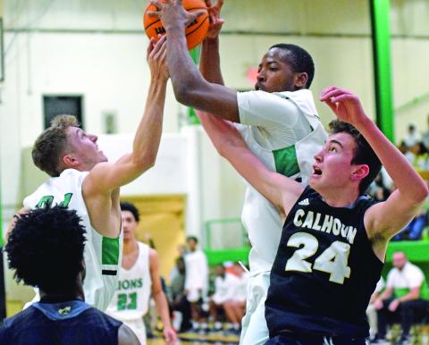 Lions Carter Alexander and JoJo Hughes (above) battle for a rebound against Calhoun Saturday in the Lions Den.