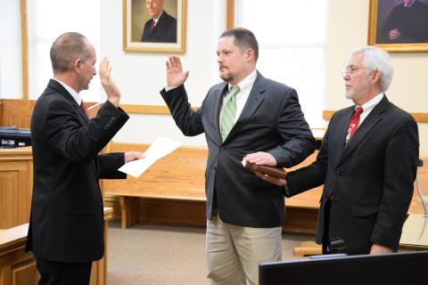 Commissioner Jason Macomson (center, during his swearing-in ceremony in 2017 as District 2 Commissioner) has announced he will run for chairman of the Franklin County Board of Commissioners.