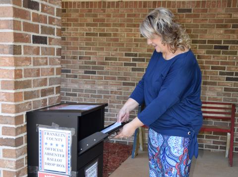 Franklin County Elections Supervisor Gina Kesler demonstrates how to drop off an absentee ballot at her office's new outside drop box that will be available for the June 9 primary.
