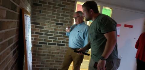 Poll watchers use flashlights to look over election results Tuesday at the Franklin County Elections and Registration Office.