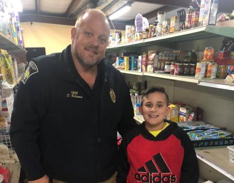 Hunter Blackmon (right), 11, a sixth grader at Franklin County Middle School, recently donated $120 to the Rainbow Pantry in Royston from money he made operating a store near Victoria Bryant State Park. The Rainbow Pantry’s Donnie Bolemon accepted the donation.