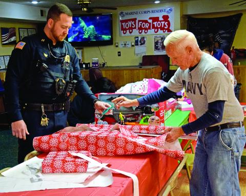 Lavonia Officer Blake Andrews and Lavonia VFW Post Commander Jim “Chief” Bright wrap presents during Saturday’s Shop with a Cop event sponsored by the Northeast Georgia chapter of the Fraternal Order of Police. (Photos by Scoggins)