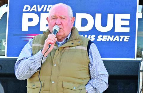U.S. Secretary of Agriculture Sonny Perdue speaks Tuesday during a rally in Royston in support of Republican Sens. David Perdue and Kelly Loeffler. (Photo by Scoggins)