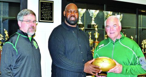 Tony Jones (center) presented a commemorative football in 2016 to then Franklin County High School Principal Brad Roberts (left) and Athletic Director Jeff Davis on the occasion of the 50th Super Bowl. The footballs were presented to the high schools of each player who played in a Super Bowl. Jones was on two Super Bowl champion Denver Broncos teams.