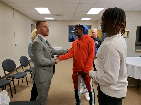 New Franklin County Lion head football coach Parker Martin (left) talks with Fredricus Oglesby  (center) and Josh Butler (right) during a meet and greet Tuesday after being officially hired by the Franklin County Board of Education. (Photo by Sinclair)