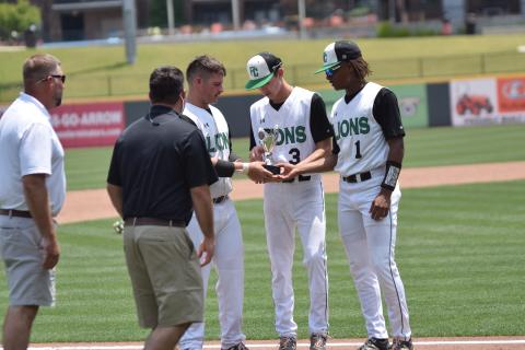 Seniors Evan Herring, J.D. Ginn and C.J. Blackwell accept the state runner-up trophy Monday at CoolRay Field in Lawrenceville.