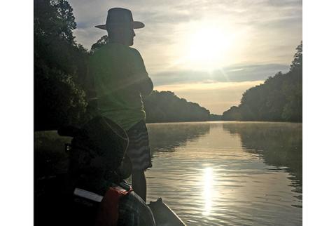 Jacob Duckett takes a turn leading the way down the Broad River on the last morning of a three-day journey down river by jon boat with friends Trevor and Miles McBath.