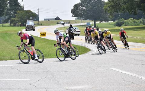 Bicycle racers make the turn into the Franklin County High School campus Sunday. (Photo by Scoggins)