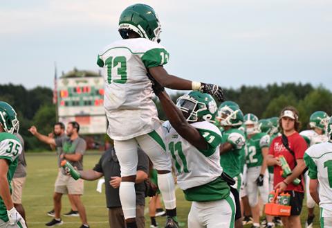 A.J. Elliott (No. 13) and Josh Butler (No. 11) celebrate a touchdown Friday in a Green-White Scrimmage held at Ed Bryant Stadium. (Photo by Scoggins)