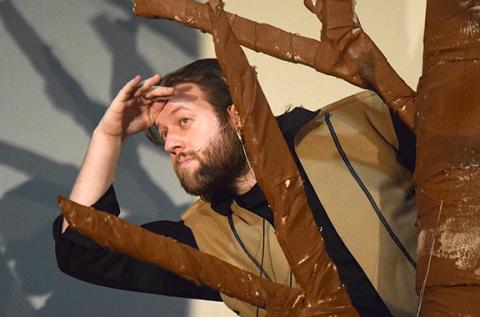 King Arthur (Josh Bryan) peeks out from behind a tree where he is hiding from his duties in "Camelot," one of the many activities planned for the weekend. (Photo by Sinclair)