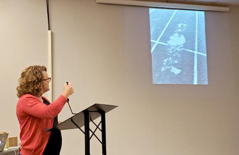 Renee Duncan shows Franklin County Board of Education members a worn part of the track at Franklin County High School. “You can’t invite people and can’t be proud of that,” Duncan said. (Photo by Sinclair)