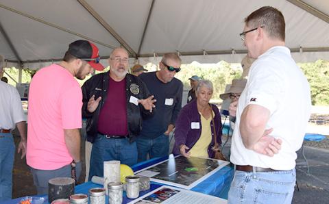 Rodney Swinson (center), who lives in the Bradford Place subdivision adjacent to where Vulcan Materials plans to build a rock quarry, shares concerns during a neighborhood information session set up by the company Tuesday. (Photo by Sinclair)