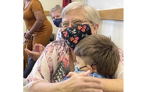 Joyce Freeman and Lethan embrace at the courthouse after his adoption is final.