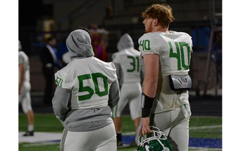 Senior Keylan Rutledge (No. 40) walks off the field for the final time in high school with injured junior center Tarryn Tate following Franklin’s loss to Oconee, now ranked No. 2 in the state. (Photo by Scoggins)