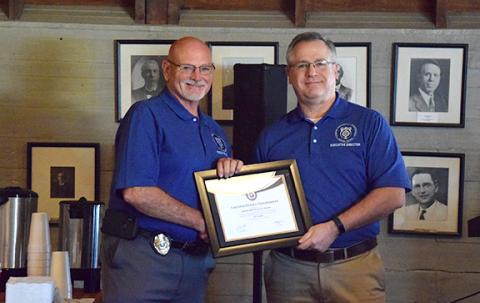Lavonia Police Chief Bruce Carlisle receives the Meritorious Gold Award from Butch Ayers, the executive director of the Georgia Association of Chiefs of Police. (Photo by Sinclair)