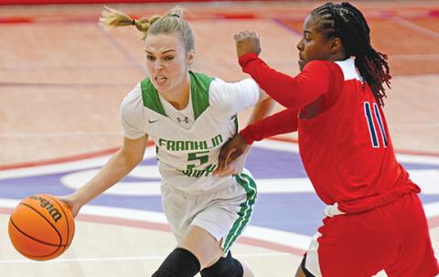 Bailey Aderholdt drives by a Winder-Barrow defender Monday in Jefferson. (Photo by Scoggins)
