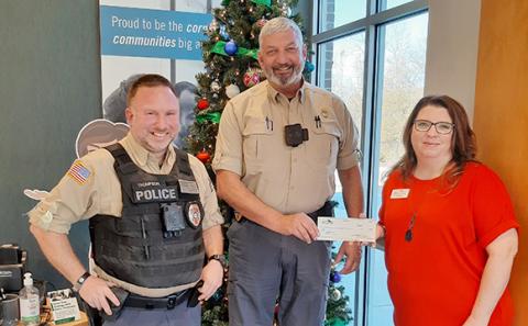 Pinnacle Bank Franklin Springs Branch Manager Carrie Brown presents a check to Franklin Springs Police Chief Jim Davis and Officer Kevin Thompson.