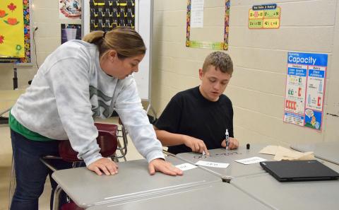 Franklin County Middle School teacher Amber Adams coaches Leland Rogers as he works on his rounding skills. (Photo by Sinclair)