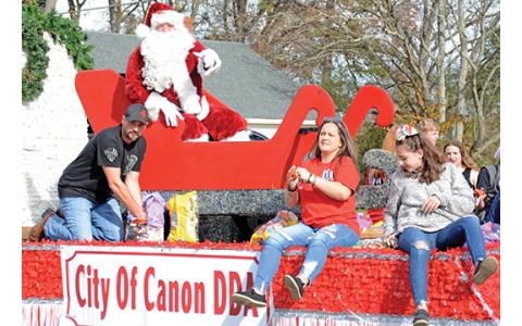 Candy filled the air Saturday as the Canon Christmas Parade made its way from the city park to just past city hall. A variety of floats, emergency vehicles, classic cars and the Franklin County Marching Pride Band celebrated the Christmas season in the annual event. (Photo by Scoggins)