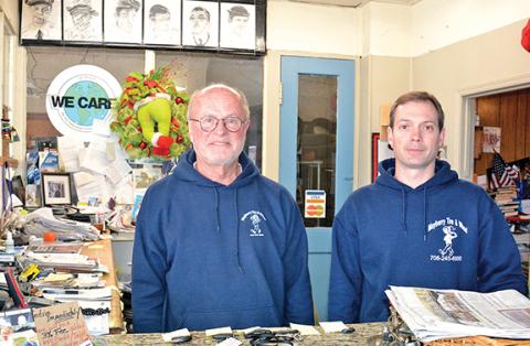 John Sullivan (left), founder of Mayberry Tire & Wheel, stands with new owner Sam Donaldson (right). Sullivan is preparing to retire from the cornerstone business in downtown Royston. (Photo by Scoggins)
