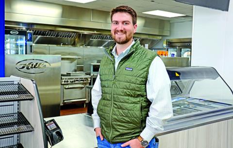 Matt Hill stands in front of Hill’s Exxon’s new state-of-the-art kitchen which will be the hub for full breakfast and lunch service in the next couple of weeks. (Photo by Scoggins)