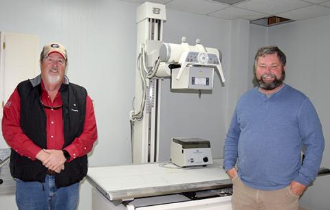 Jerry “Scoot” Rice and Scott Bailey are donating x-ray machine equipment left in the former medical building they turning into a storage facility. (Photo by Sinclair)